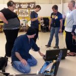A couple of the students excitedly check out a donated coronet.